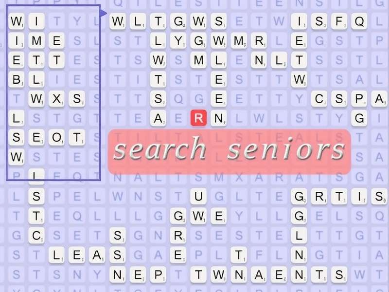 A joyful senior couple in India solving a large-print word search puzzle together at home